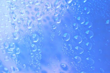 Naklejka na ściany i meble water drop background on abstract blue clear glass