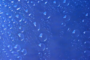 water drop background on abstract blue clear glass