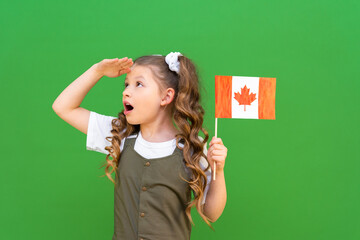 A Canadian flag in the hands of a little girl on an isolated background. moving to Canada and getting an education.