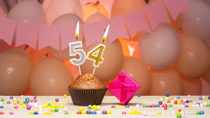 Decorations with balloons and a happy birthday candle with the number 54 for a woman. Happy...
