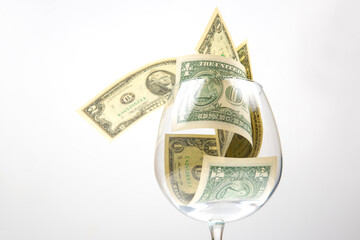 dollar banknotes money lies in an empty wine glass. business in the wine industry. alcohol marketing