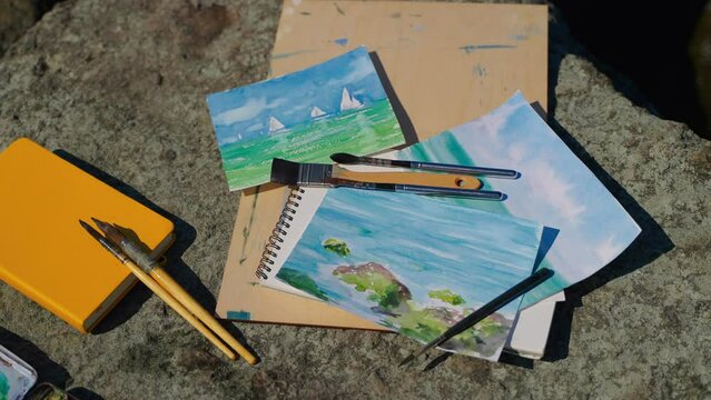 Art supplies and watercolor seascapes