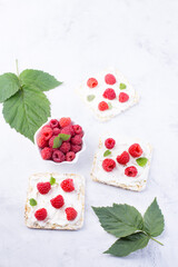 Toast with cream cheese and fresh raspberries. A delicious summer dish for breakfast.