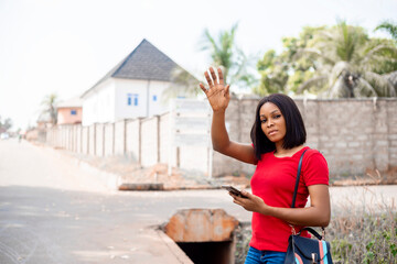 Young Business african Woman With Smart Phone Hailing Taxi