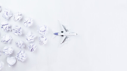 model of an airplane taking off on a white background. Crumpled paper clouds.view from above. the...
