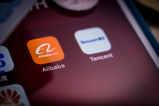 Kumamoto, Japan - Mar 5 2020 :
Close up of Alibaba logo, founded on 4 April 1999 in Hangzhou, Zhejiang, with Chinese big tech company logos (Baidu, Tencent and Huawei) & money on an iPhone.