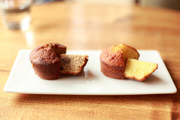 Two brown muffins on a white plate