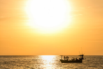 Silhouette of a fishing boat during sunset