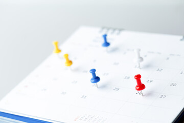 Fototapeta premium Thumbtack in calendar concept for busy, appointment and meeting reminder, planning for business meeting or travel planning concept.