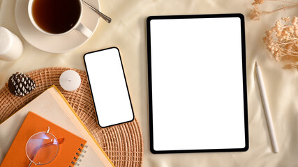Cozy minimal feminine workspace with tablet computer and smartphone mockup