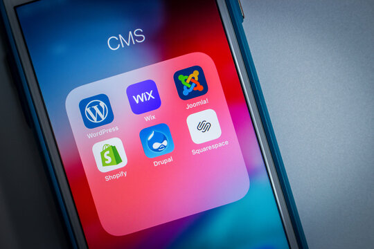 Kumamoto, Japan - May 7 2020 : Popular CMS icons (WordPress, Wix, Joomla!, Shopify, Drupal and Squarespace) on iPhone screen.