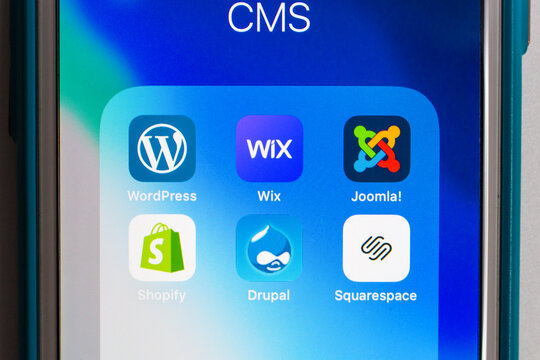 Kumamoto, Japan - May 7 2020 : Popular CMS icons (WordPress, Wix, Joomla!, Shopify, Drupal and Squarespace) on iPhone screen.