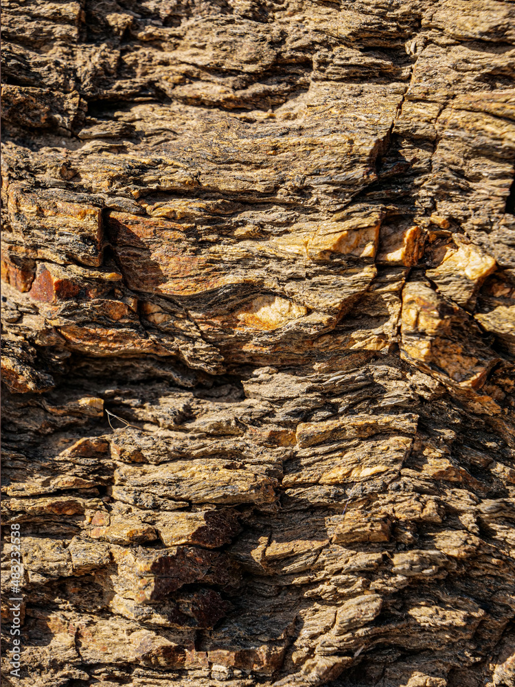 Sticker A closeup shot of a rough rock wall texture,  ironoxid and quartz in layers