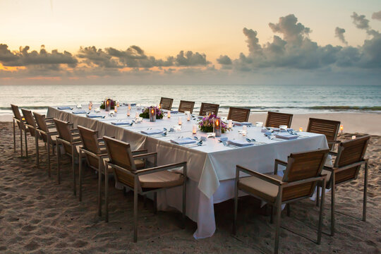 long dinner table on the beach.