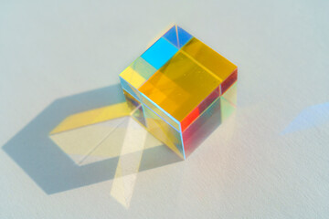 Cubic rainbow prism on a white background.