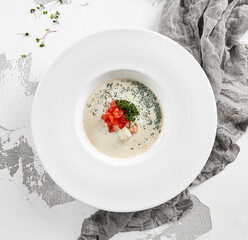 Fish creamy soup in norwegian style. Finnish fish soup with tomato, dill and creamy. Scandinavian food - salmon creamy soup. Seafood chowder with vegetables and fish. Norwegian cuisine.