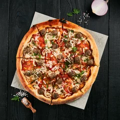  Homemade pizza with meatball on black wood background.  American pizza with meat and cheese. Italian pizza  in rustic style. Junk food on dark backgroundp87 © Ryzhkov