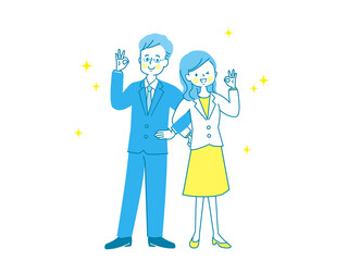 腕を組んでOKサインする男女のカップル