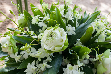 Floral arrangement at a wedding ceremony on beach.