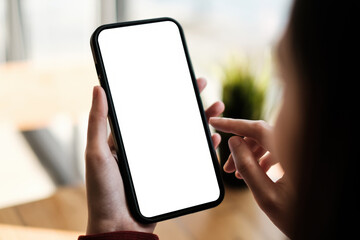 Business woman holding cell phone show something on display at cafe shop. Blank screen for your advertising.