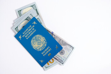 Passport citizen Republic Kazakhstan blue with coat arms and pack hundred-dollar bills inside, on white background.