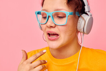 funny girl wearing headphones blue glasses close-up emotions isolated backgrounds unaltered