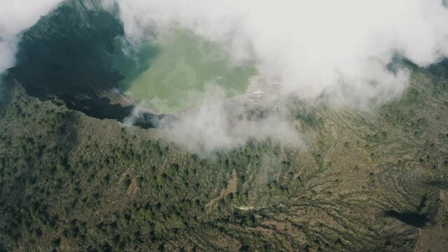 El Chichonal Volcano with green sulfuric lake in crater in Chiapas, Mexico - aerial drone shot