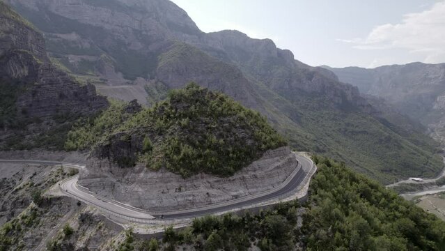 Drone video of empty description plane over the "Rrapsh Serpentine" mountain pass on the Sh20 road in Grabom, Albania, you can see a motorcycle passing by.
Leqet e Hotit