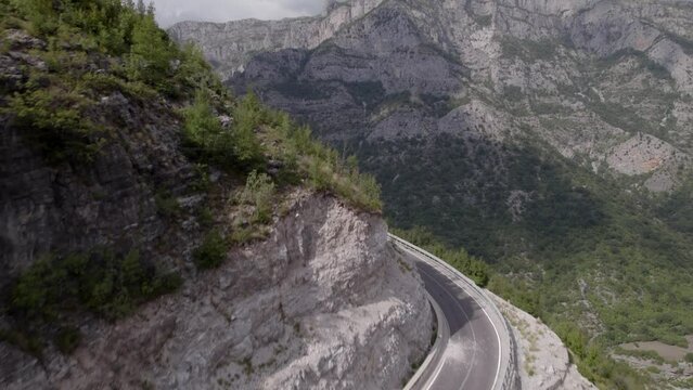 Drone video of ascending frontal discovery plane over the mountain pass "Rrapsh Serpentine" on the Sh20 road in Grabom, Albania, ends in front of the mountain
Leqet e Hotit