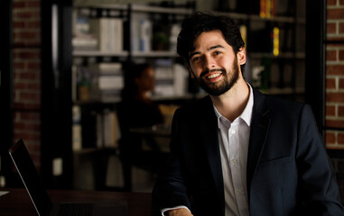 Portrait closeup shot of Caucasian handsome bearded and mustache professional successful male businessman lawyer in formal luxury suit sitting look at camera