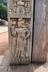 Stupa No 1, North Gateway, Left Pillar, Inside  Panel 4:  Dvarapala or guardian clad in dhoti. Shown standing wearing many ornaments and heavy earrings.