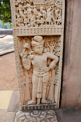 Stupa No 1, East Gateway,  Left  Pillar, Inside Panel 4:  Dvarapala, Clad in dhoti. Shown standing wearing many ornaments and heavy earrings here.