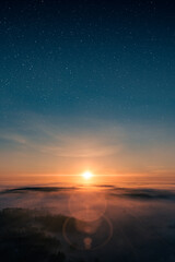 Beautiful scenic view of misty landscape in sunset with epic stars in the sky. Tranquility and spirituality.
