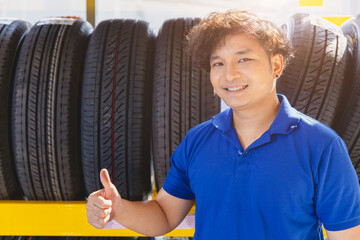 Car tire on shelf with salesman sale agent happy to service in tyre shop. Good quality vehicle...