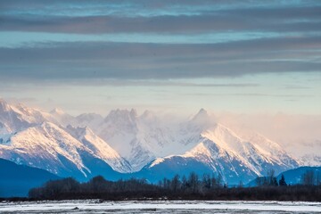 Fototapeta na wymiar Snowcovered Mountains in Alaska. Chilkat State Park. Mud Bay. HAINES. Alaska. USA