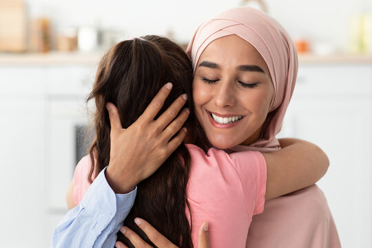 Mother's Love. Beautiful Muslim Woman In Hijab Hugging Her Little Daughter
