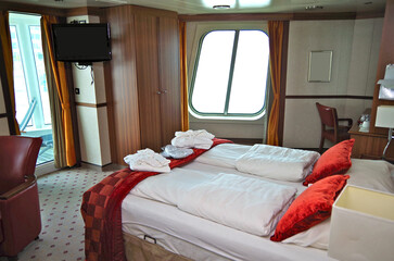 Cozy bedroom living room inside cabin suite stateroom in stylish Scandinavian interior design...