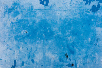 Old grunge wall painted by blue color.