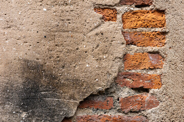 Brown grunge and rough cement wall with cracking part.