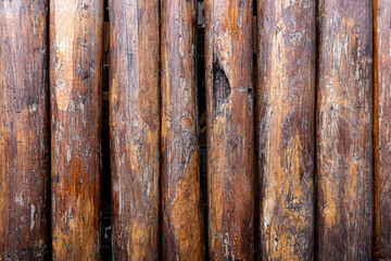 Backdrop of big brown tree logs sorting in vertical.