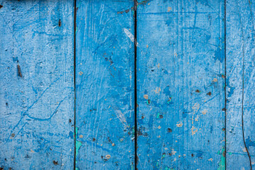 Close up on painted blue wooden background with scratch.