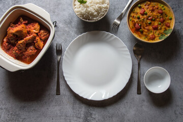 Empty plate on a background with use of selective focus along with food items to be served