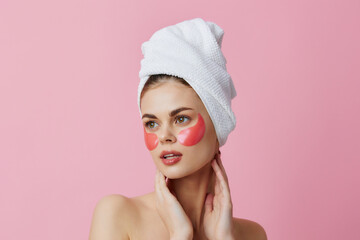 woman pink patches on the face with a towel on the head close-up Lifestyle