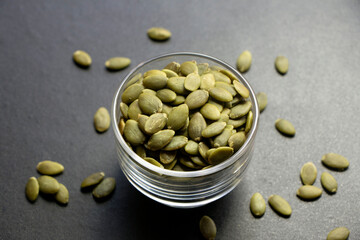 Heap of pumpkin seeds in a glass bowl