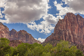 Large orange red rock formations and vistas of desert plants leading to mountains and valleys in Sedona, Arizona adds to the beauty of the wilderness