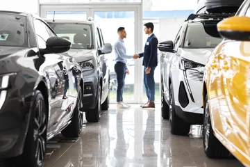 Foto op Canvas Customer and sales assistant shaking hands, car showroom interior © Prostock-studio