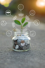 Saving money by hand puting coins in jug glass on nature background