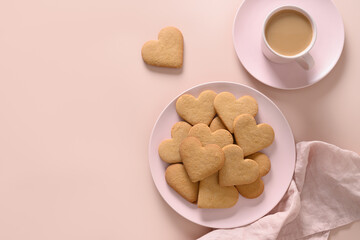 Valentine's Day coffee with milk and heart shaped cookies on pink plate. View from above. Space for your greetings.