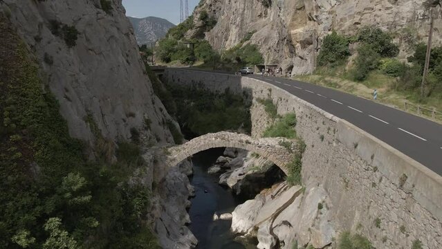 Ancient Roman stone arch bridge across Agly river in French Pyrenees