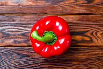 red pepper lying on a brown background
